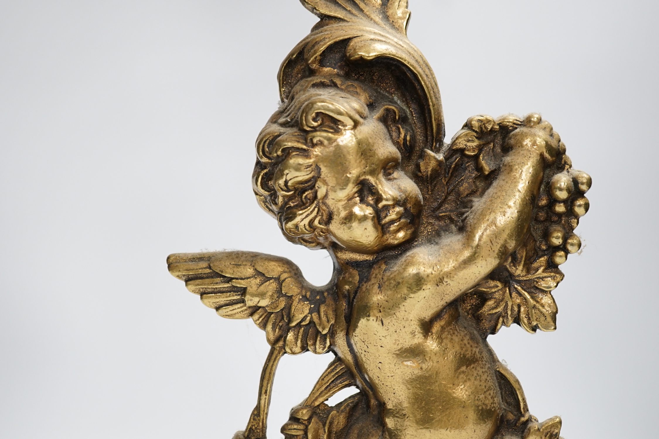 An Edwardian cast brass Cupid door porter, 49cm high